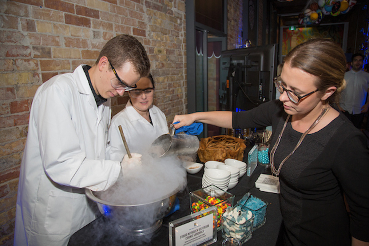 Three people making liquid nitrogen ice cream.