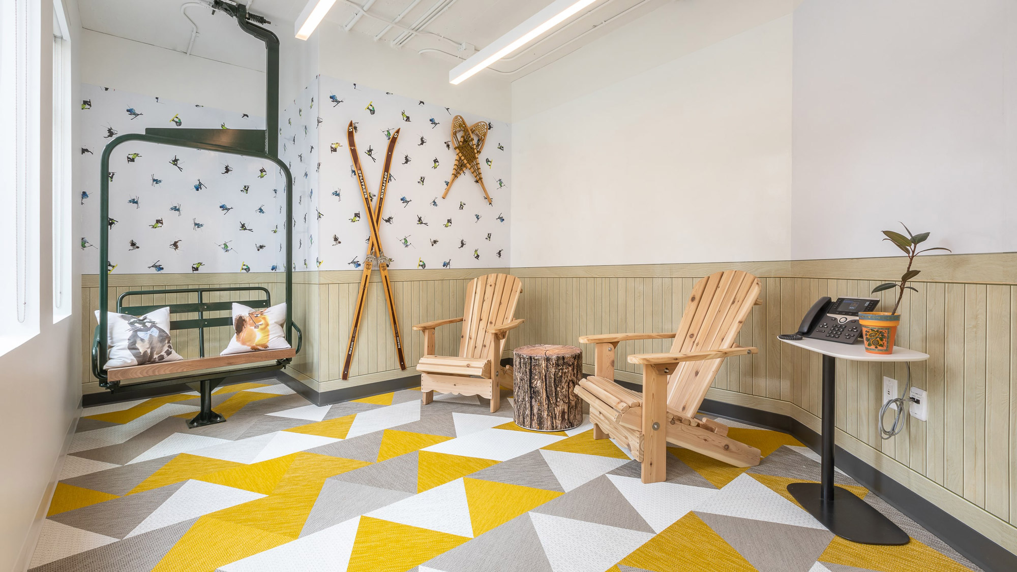 RBC Borealis Vancouver office ski themed room, with a ski lift, lake chairs and ski patterned wallpaper.