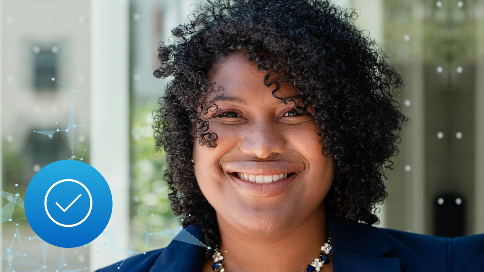 Kishwana Peck, headshot next to a blue and white checkmark representing our RESPECT AI fairness interview series.