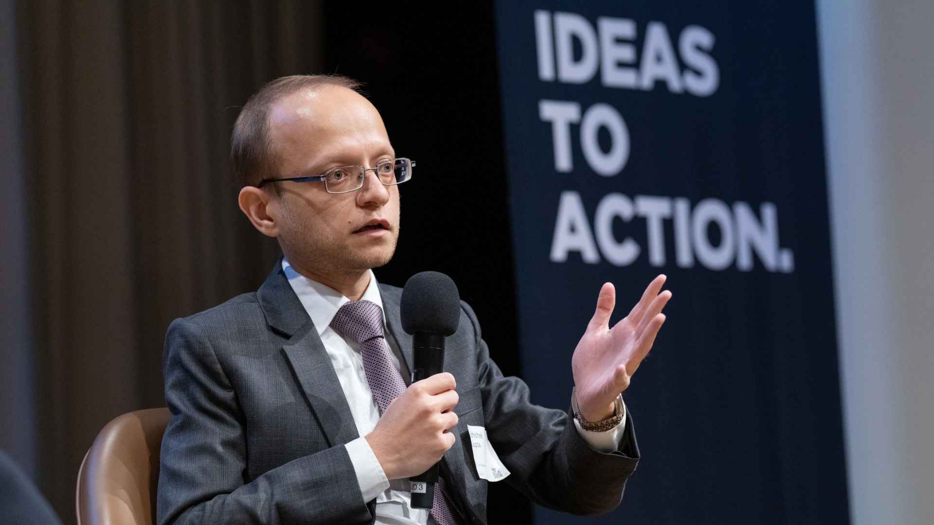 photo of abhishek gupta speaking on stage